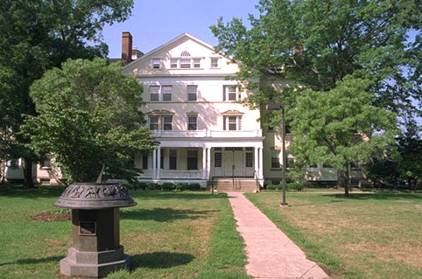 A large historic house with a large lawn